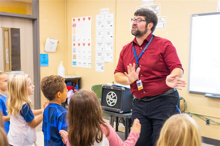 Teacher dancing with his students in class